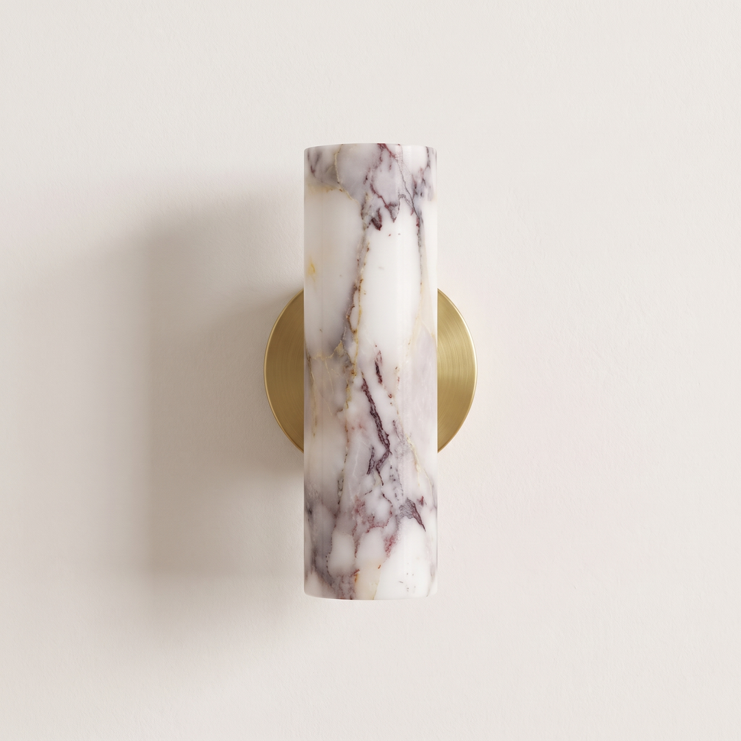 Calacatta Viola marble wall light with round brushed brass backplate, switched off, on a plaster wall
