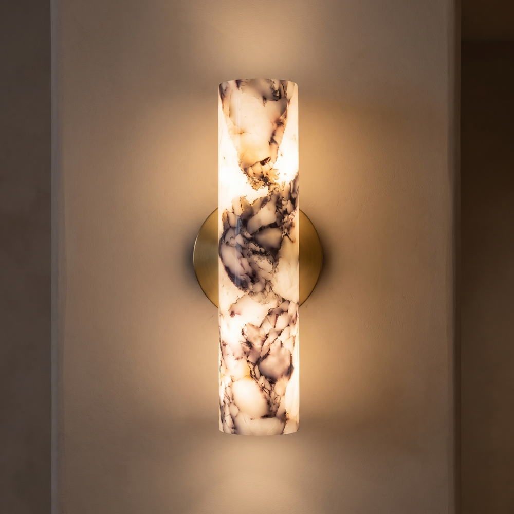 Calacatta Viola marble wall light switched on, warm light glowing through the polished marble in a hallway