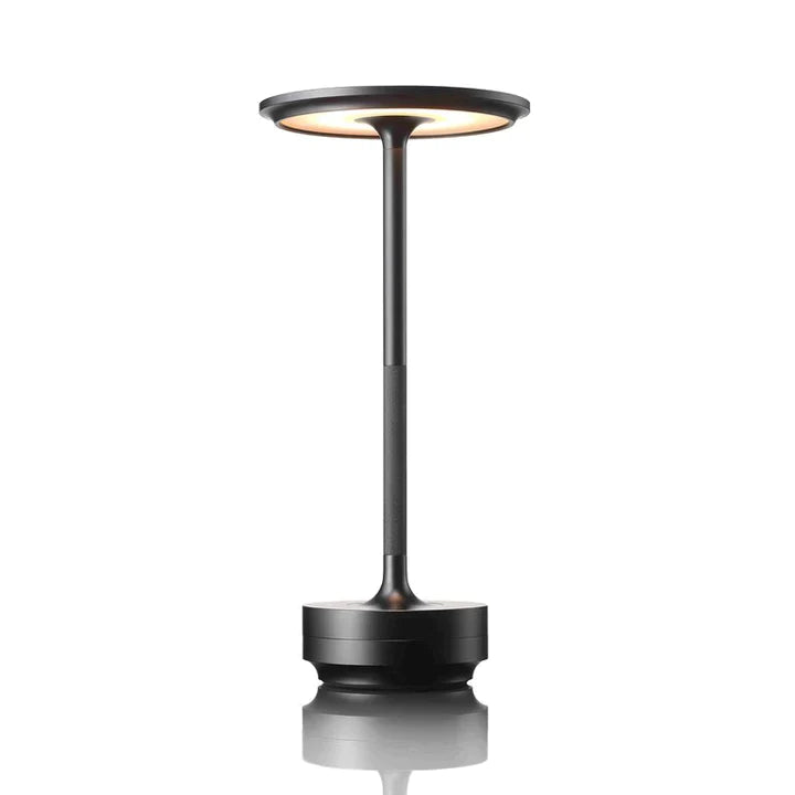 Black cordless LED table lamp, front view, lit warm white