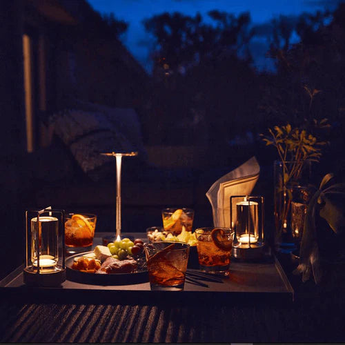 Cordless table lamp lit on an outdoor table at dusk