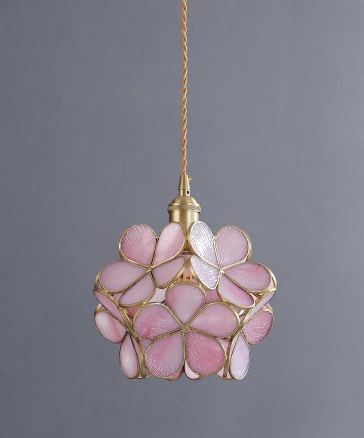 Glass Petal Pendant Light in cherry blossom pink glass against a grey wall