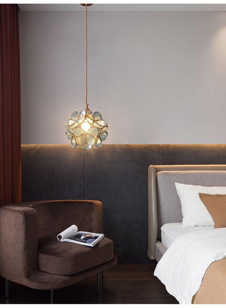 Glass Petal Pendant Light lighting a bedroom above a side table
