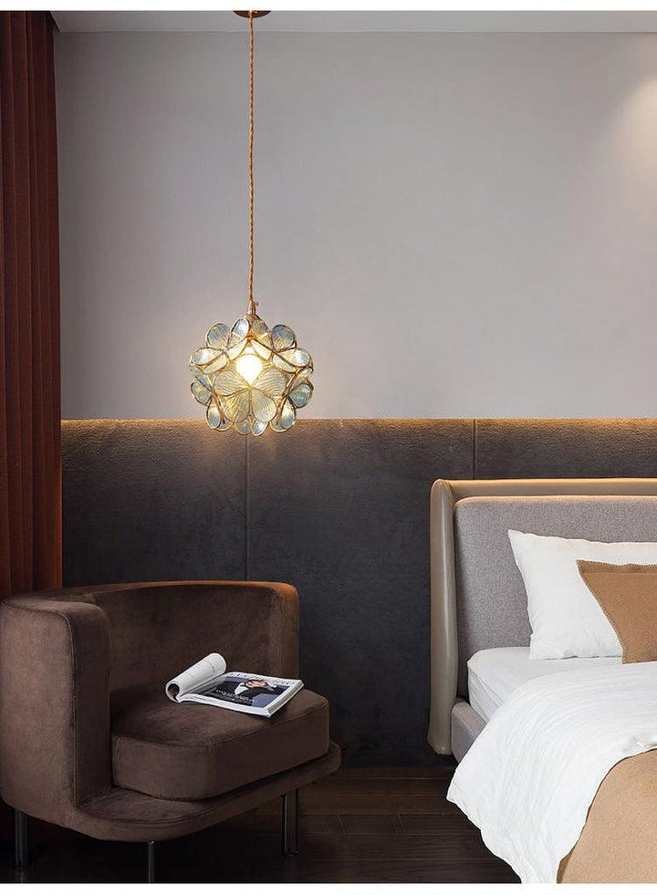 Glass Petal Pendant Light lighting a bedroom above a side table