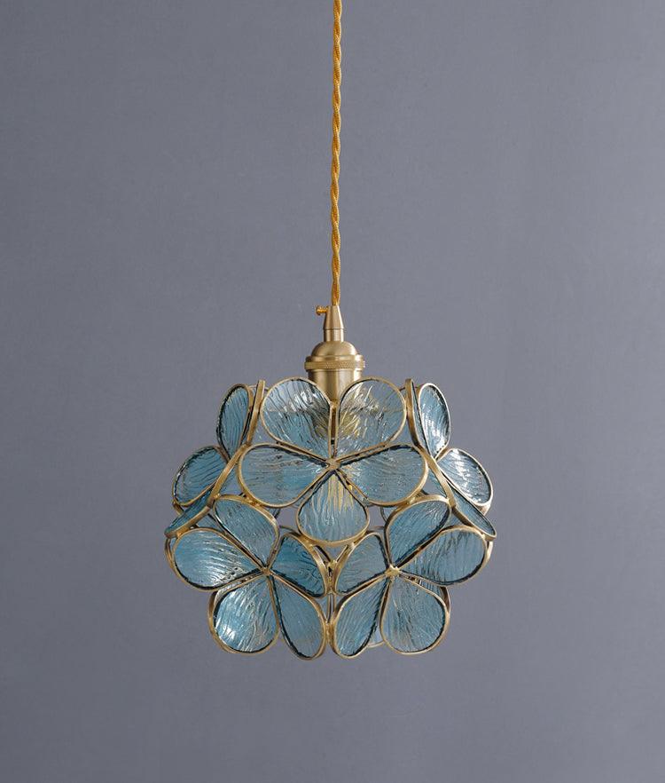 Glass Petal Pendant Light in blue tinted glass against a grey wall