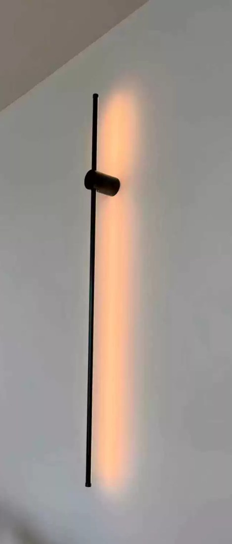 Contemporary Linear Wall Light installed on a wall, showing the mount positioned near one end of the bar